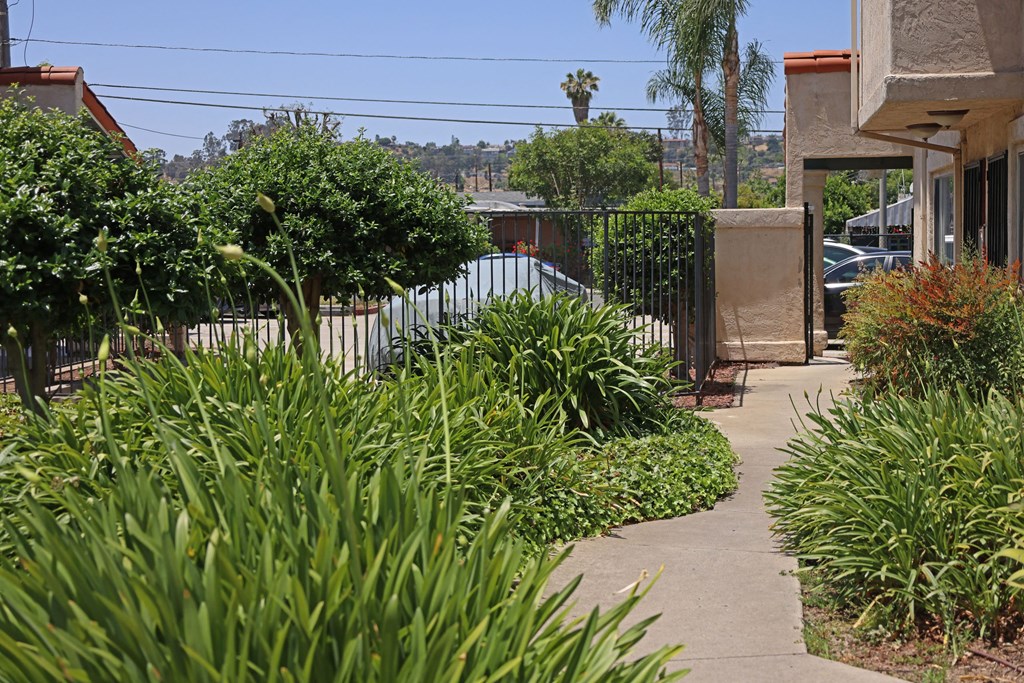 Garden walkway to apartments at Lone Pine Townhomes in El Cajon, California.