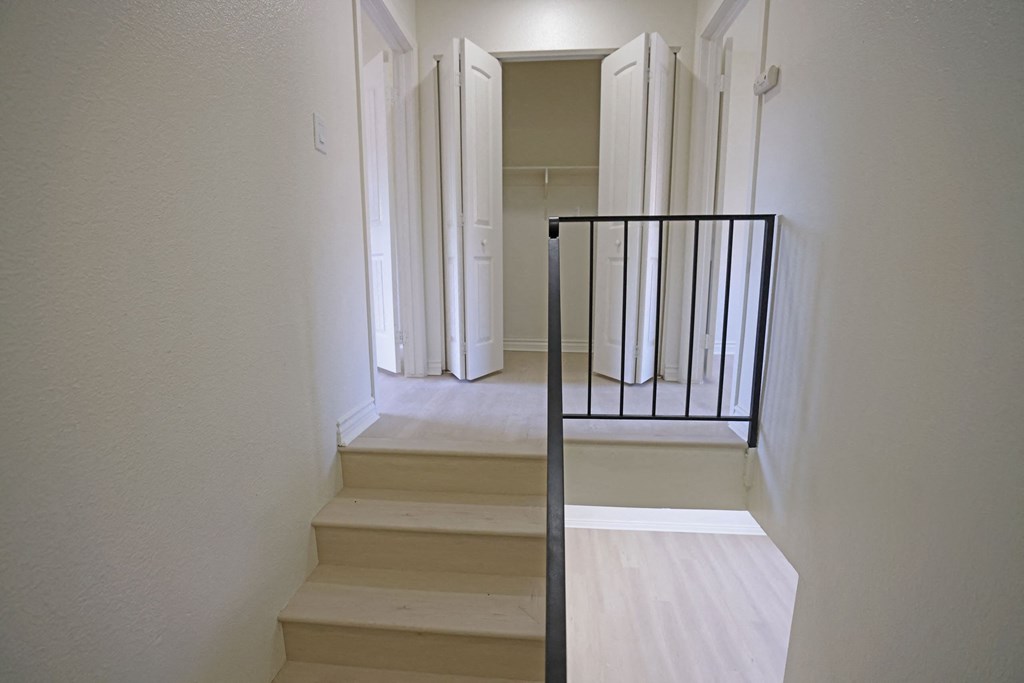 Stairs to two large bedroomw with central washer/dryer hookups closet at Lone Pine Townhomes.