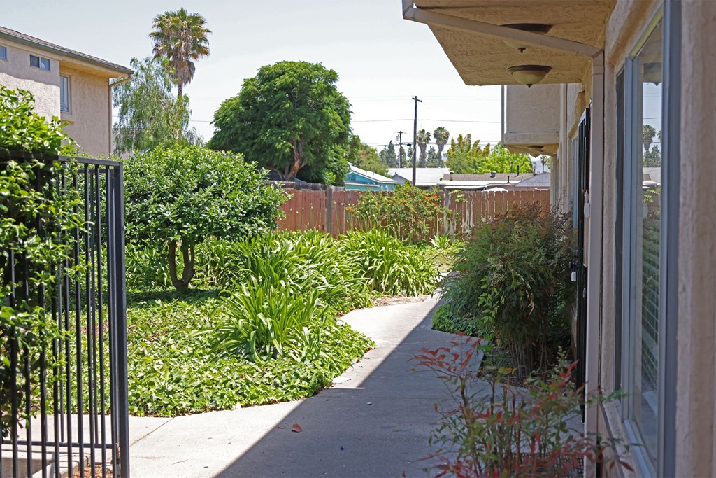 Garden path to apartment units at Lone Pine Townhomes in El Cajon, California.