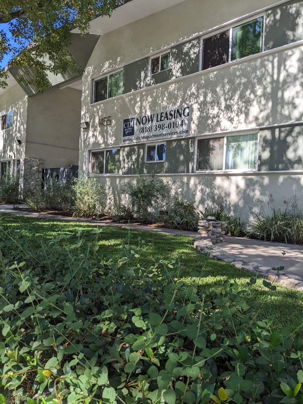 Shaded grassy area along front of Los Robles Apartment building in Pasadina, California.