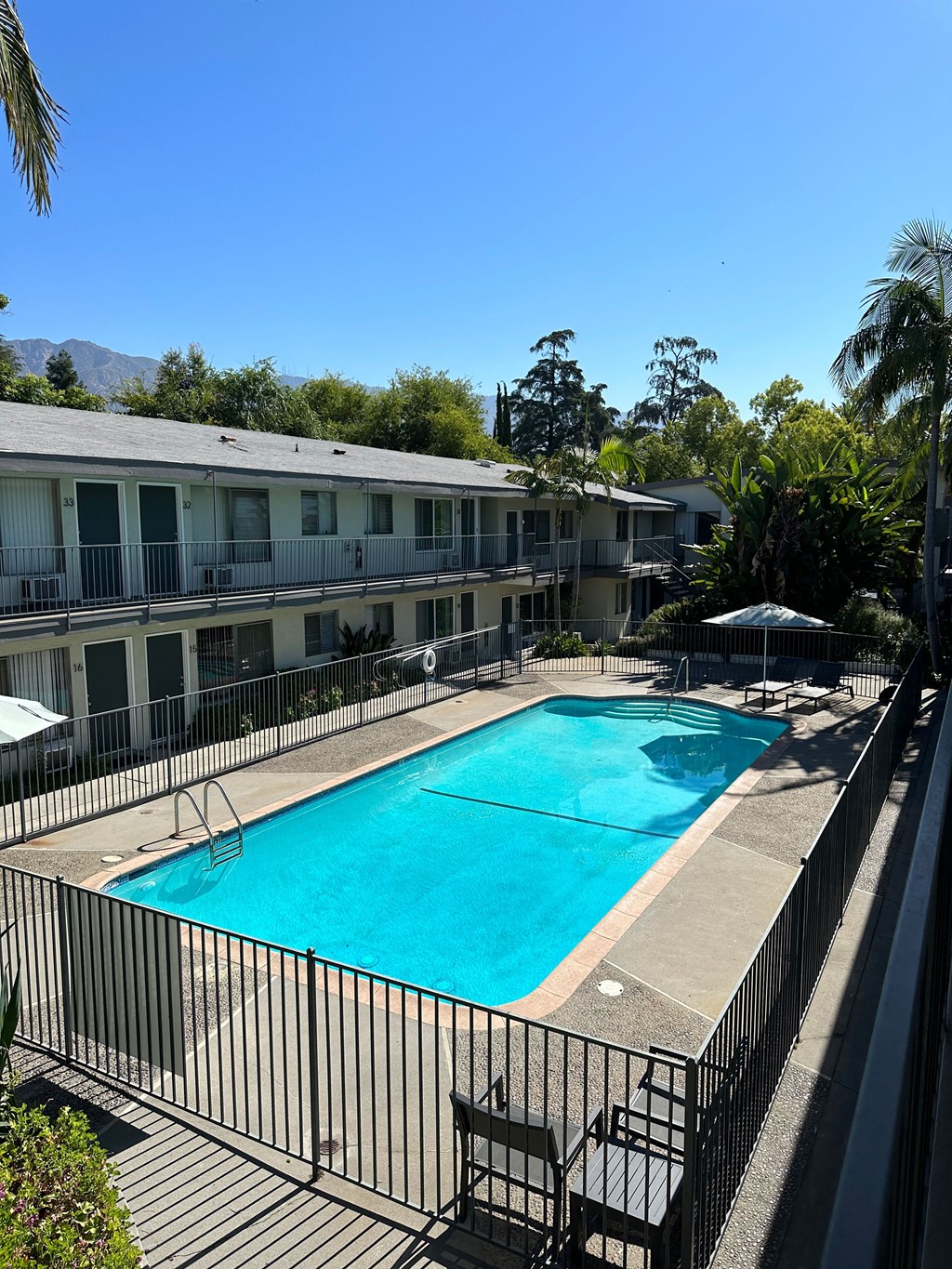 View of swimming pool and sun deck at Los Robles Apartments in Pasadena, California.