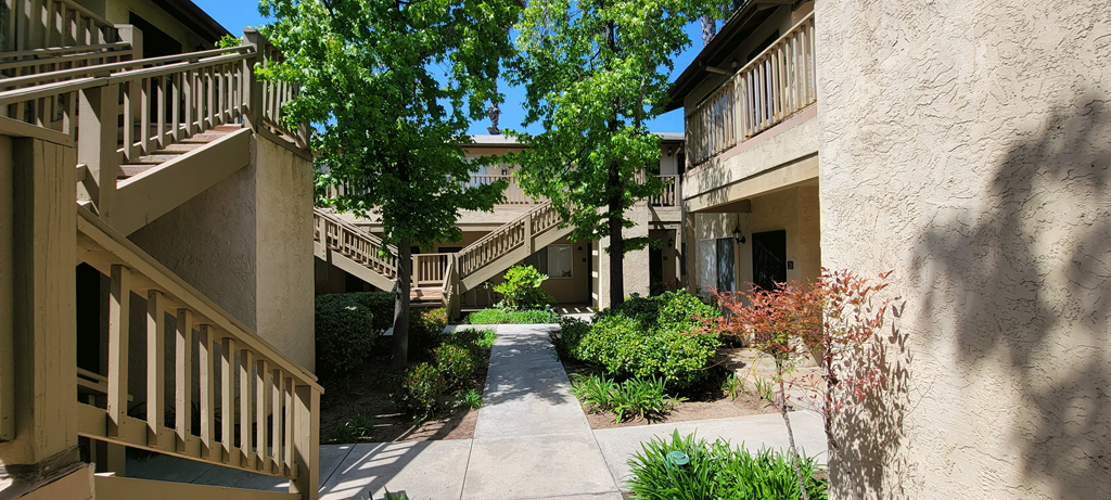 Serene walkway between apartment buildings at Sierra Heights Apartments.