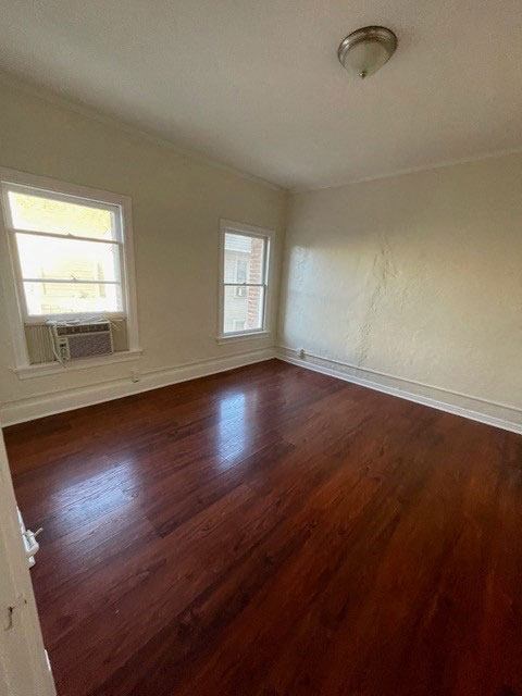 Great natural light and beautiful hardwood flooring in bedroom at Molino Del Mar Apartments in Pasadena, California.