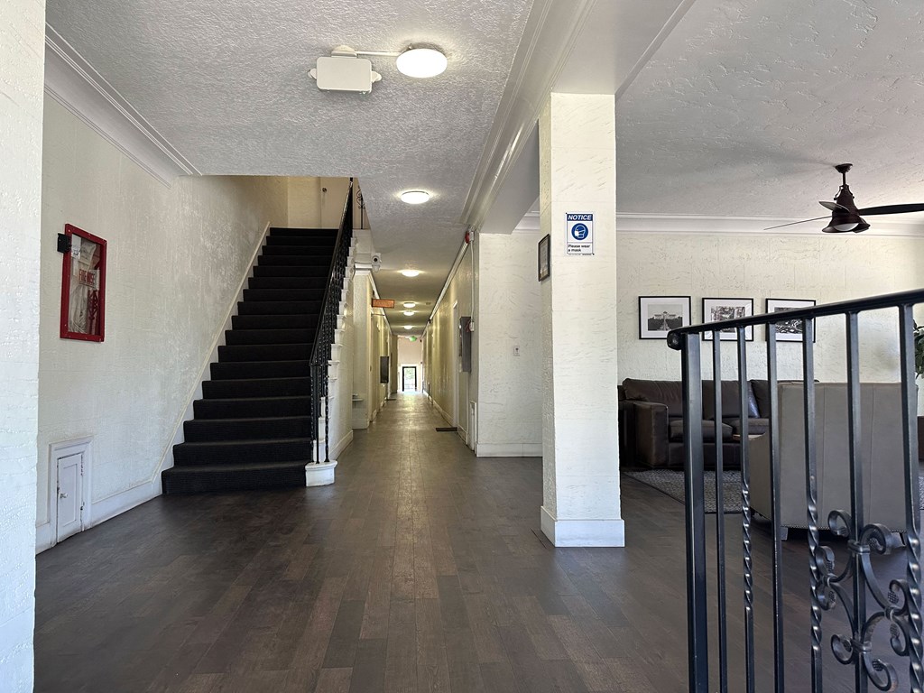 Front lobby view of hallway and stairway to apartment units at Molino Del Mar Apartments in Pasadena, California.