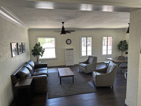 a living room with couches and chairs and a table