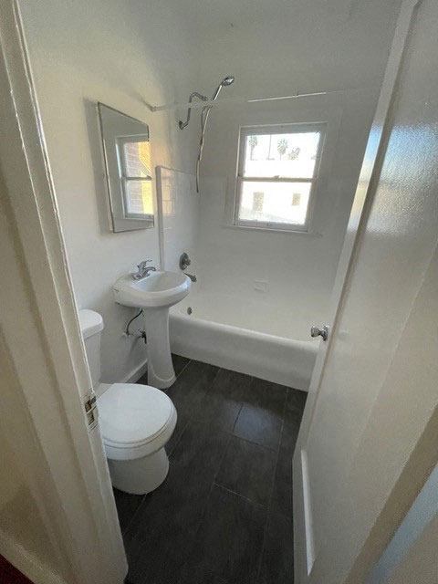 Bathroom with white fixtures and natural light in apartment unit of Molino Del Mar Apartments in Pasadena, California.