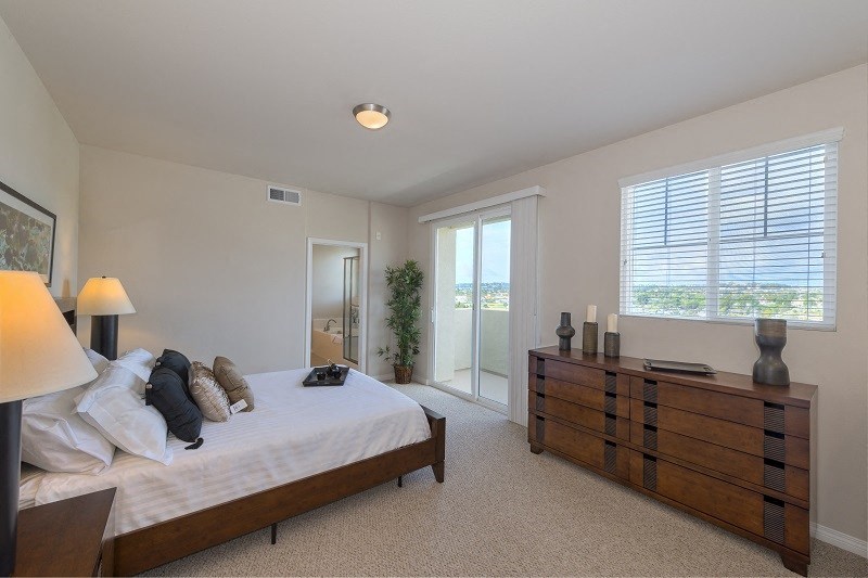 Master bedroom ensuite with private balcony at Costa Pointe Luxury Townhomes in Carlsbad, California.