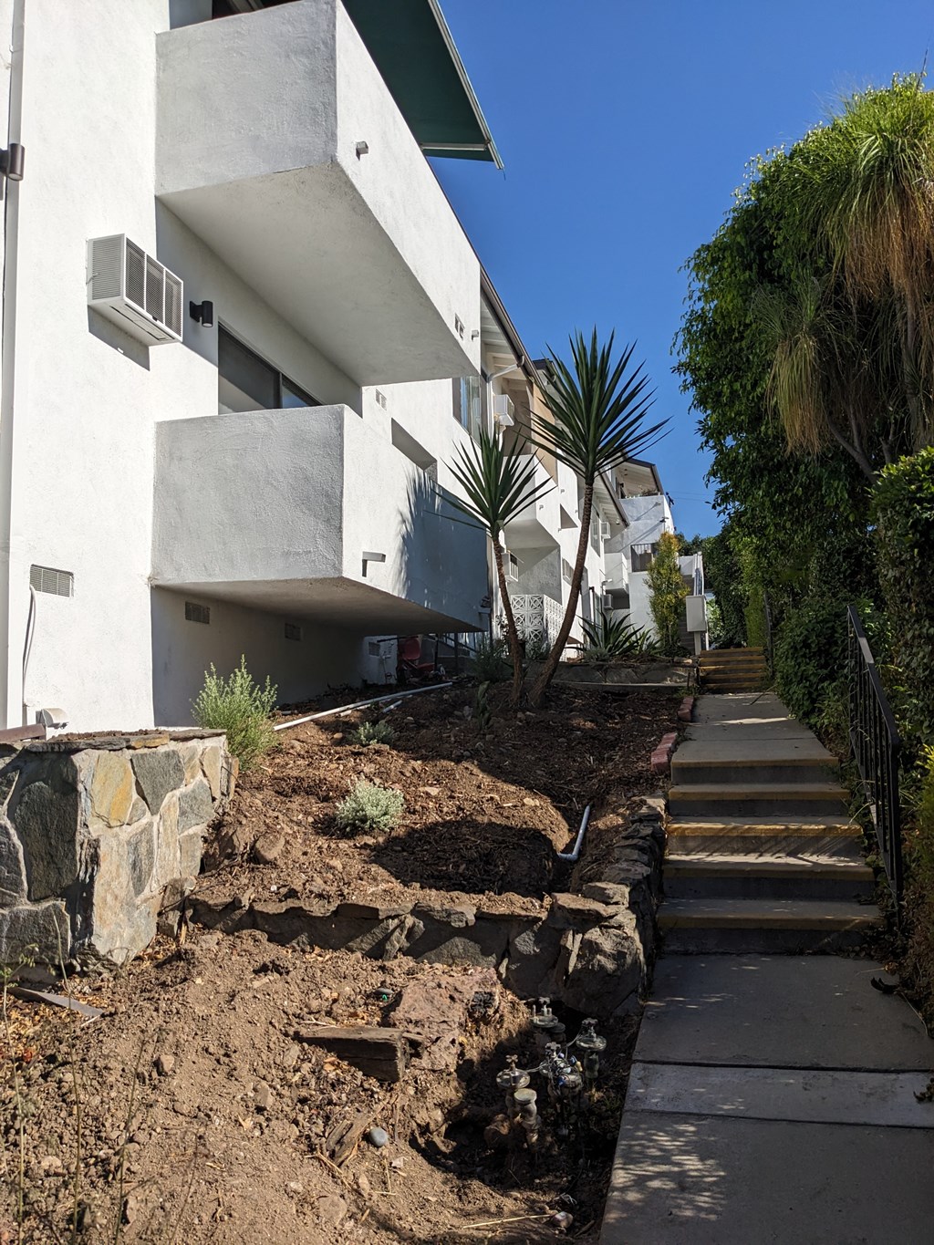 Private balconies and mature landscaping at the Hardison Apartments in Pasadena, California.