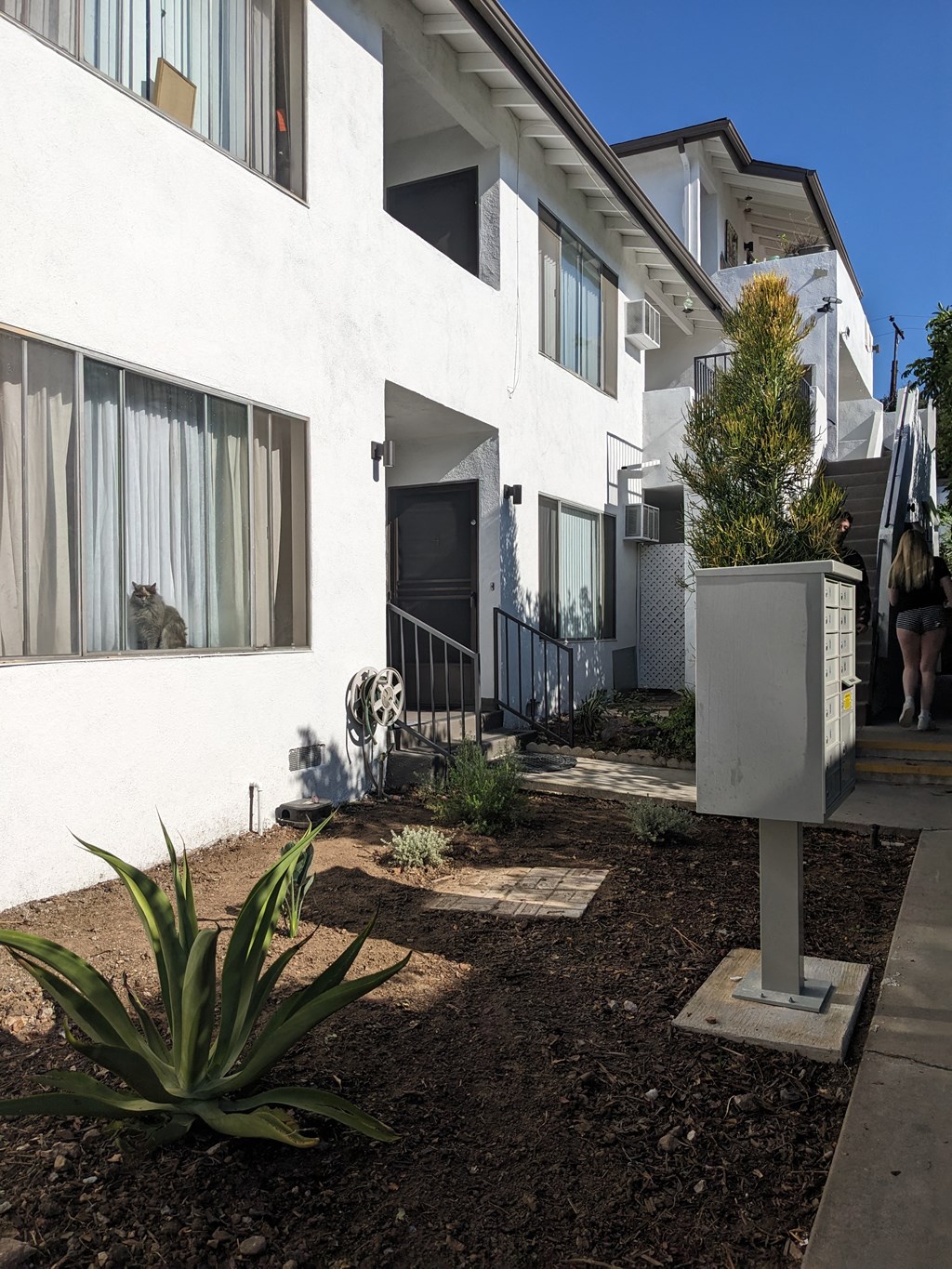 Walkway along side of The Hardison Apartments showing mailboxes and enterance in Pasadena, California.
