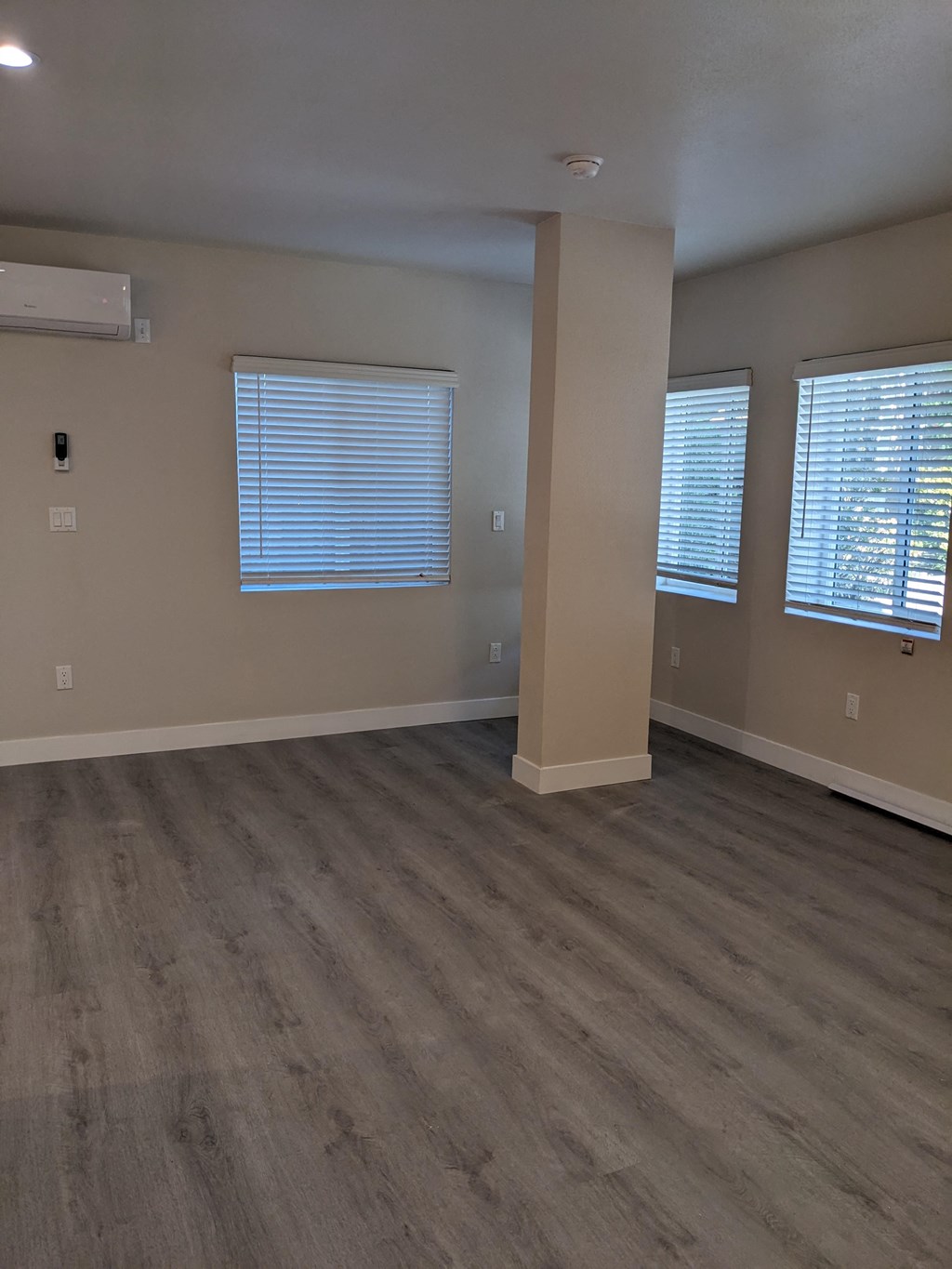 Main room with great windows and air conditioning at The Hardison Apartments in Pasadena, California.