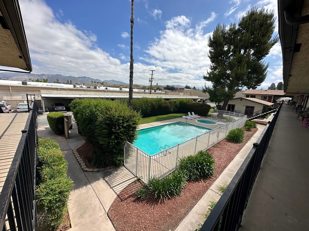 View of swimming pool and mature landscaping at Park Yale Apartments in Hemet, California.