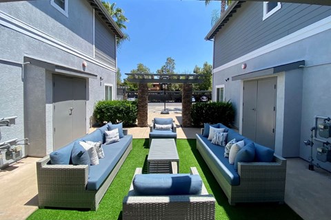 Community patio with couches at the Nines Townhomes in Escondido, California.