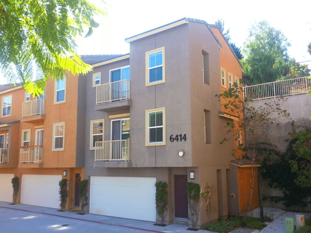Two story townhomes with attached garages and two balconies at Serenata Townhomes in San Diego, California.