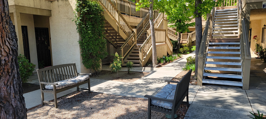 Shaded sitting area between apartment buildings at Sierra Heights.