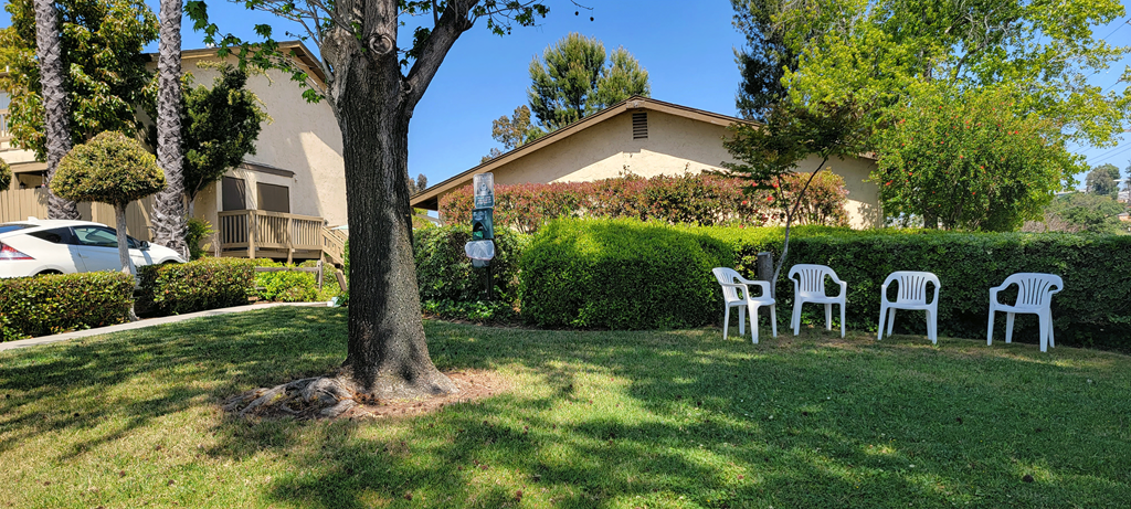 Shaded sitting area outside the clubhouse at Sierra Heights Apartments.