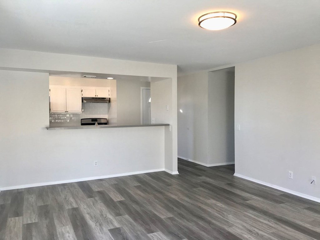 Living room and open kitchen at Summer House Apartments in Ventura, California.