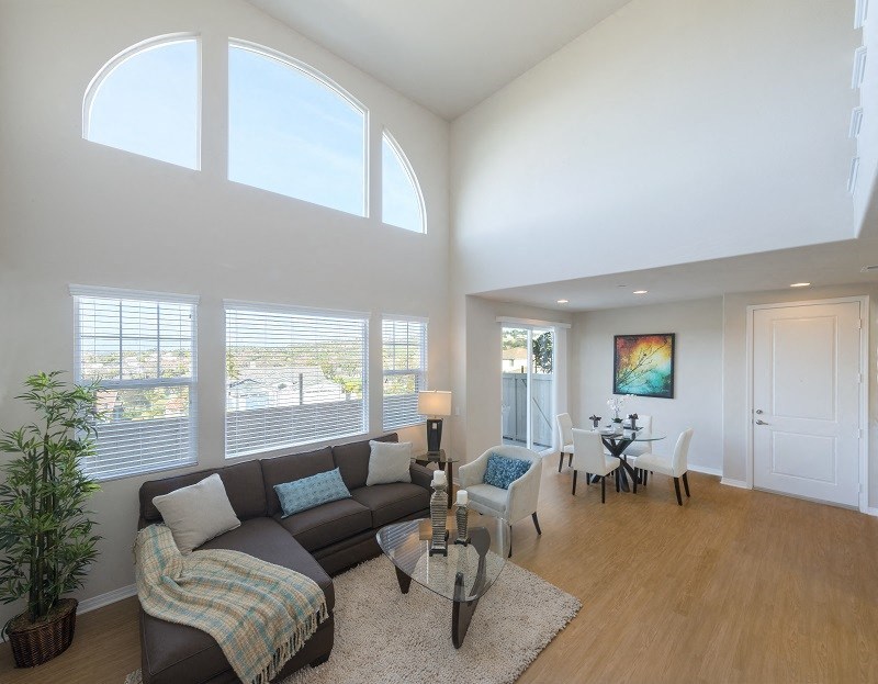 Large open living room with great windows and views in a Surfside unit at Costa Pointe Luxury Townhomes in Carlsbad, California.