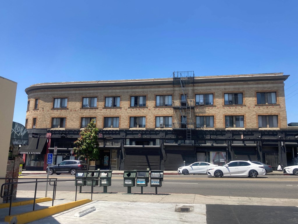 Street view of the brick building with studio apartments at The Western at Rosewood in Los Angeles, California.