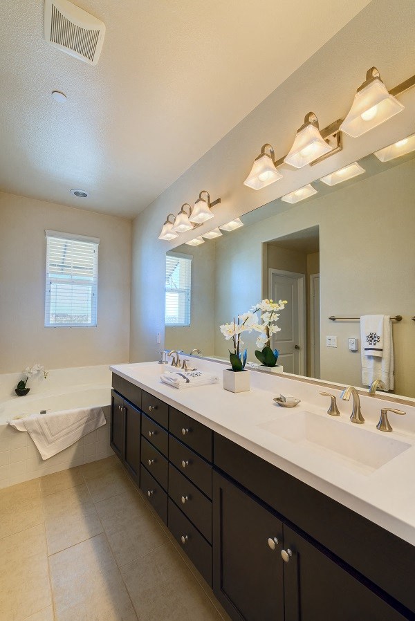 Master bathroom with dual sinks in Torrey unit at Costa Pointe Luxury Townhomes in Carlsbad, California.