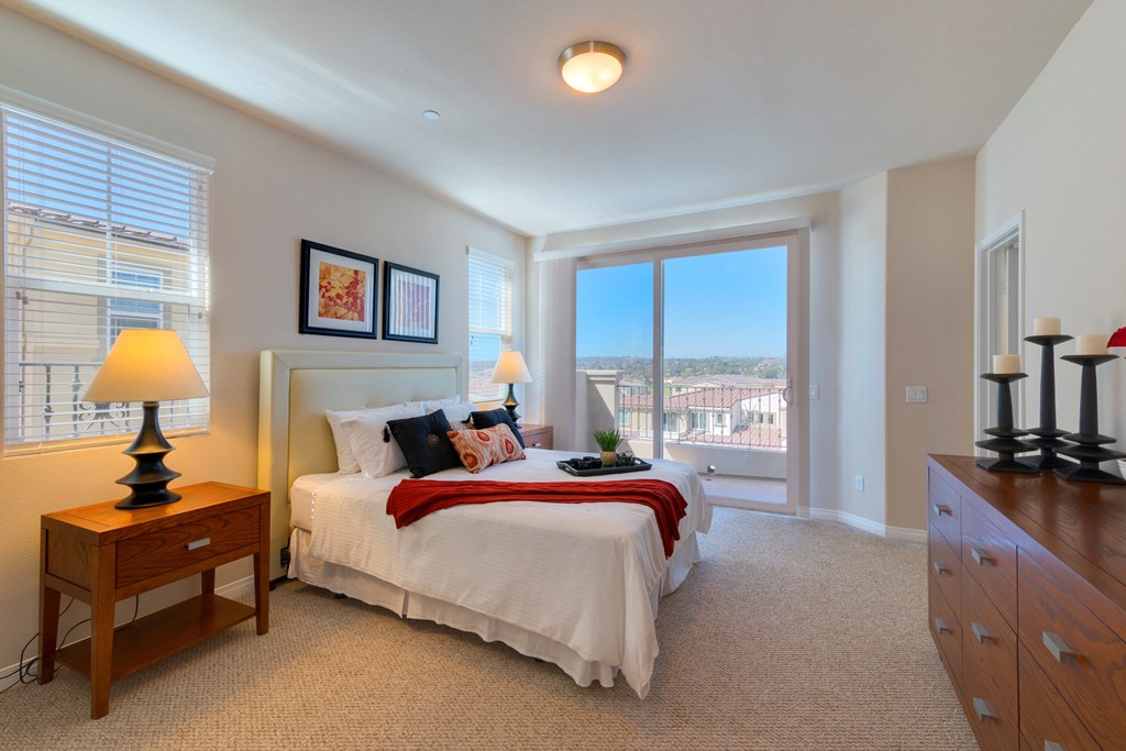 Large bedroom with private porch in Torrey unit at Costa Pointe in Carlsbad, California.