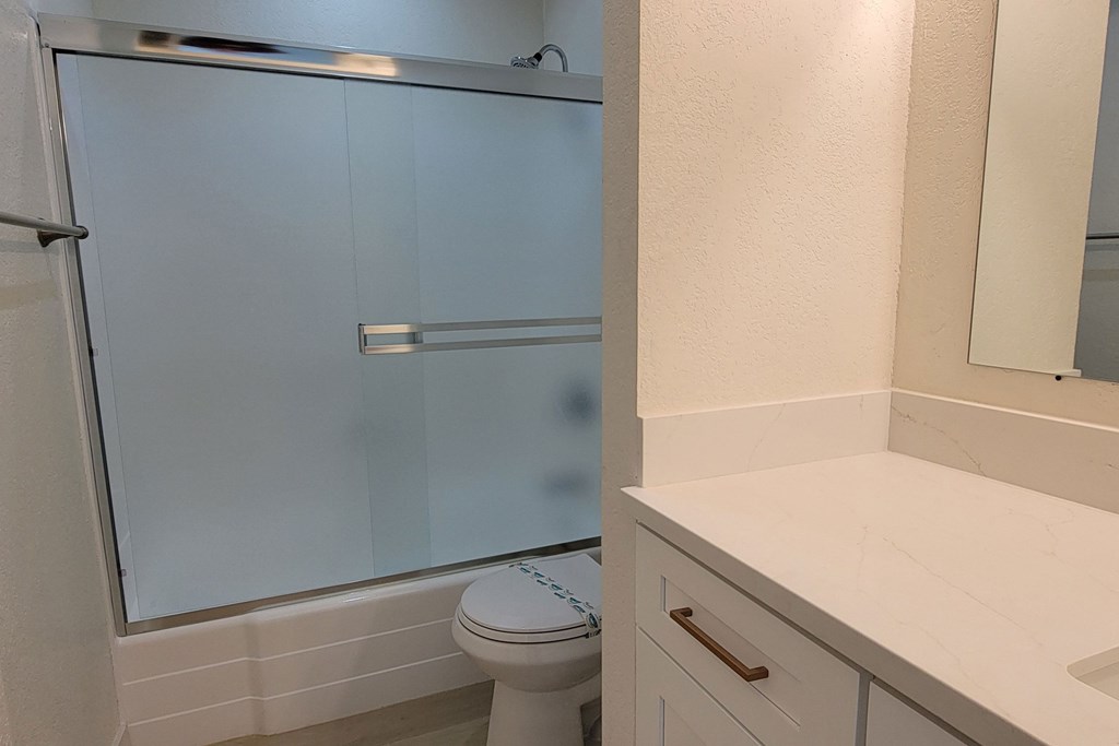 Bathroom tub and shower view in unit 17 at The Willows at Washington apartments in El Cajon, California.