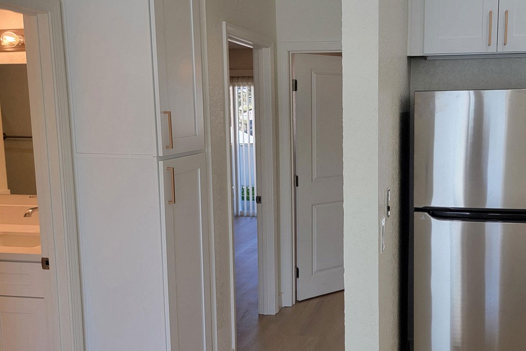 View of bedroom hallway with closets in unit 17 at The Willows at Washington apartments in El Cajon, California.