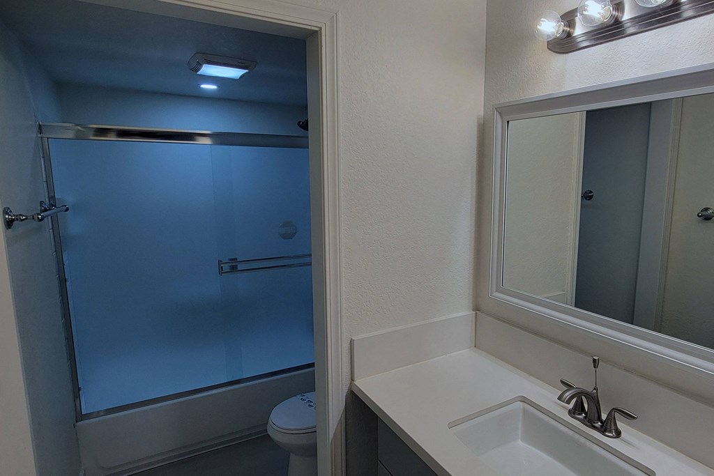 Bathroom sink and white cabinets in unit 21 at The Willows at Washington apartments in El Cajon, California.