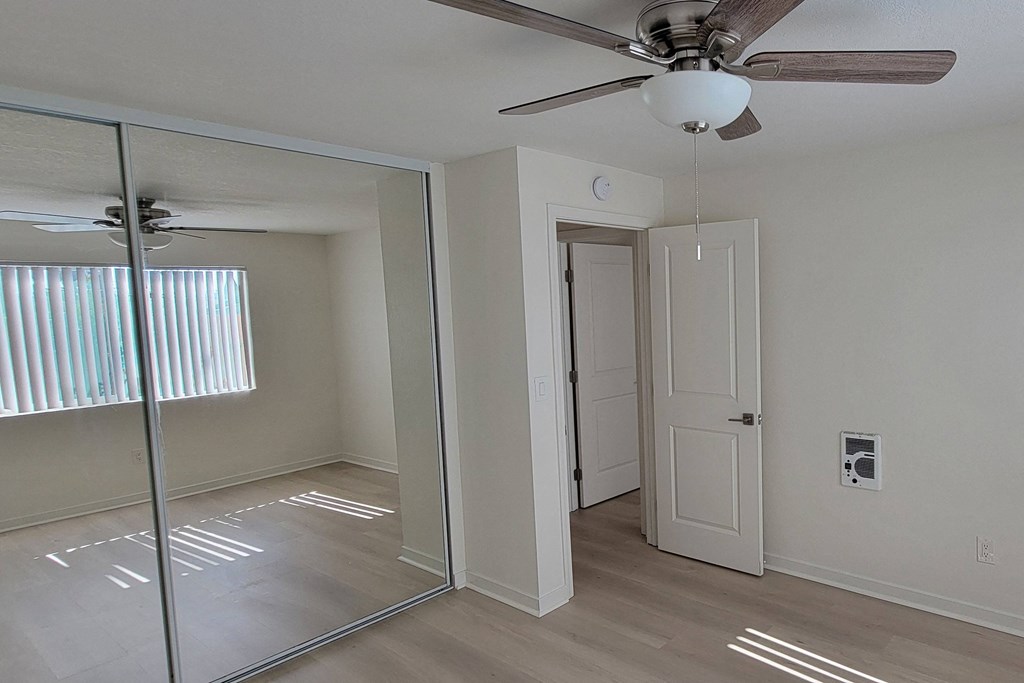 Bedroom one with large closets in unit 21 at The Willows at Washington apartments in El Cajon, California.