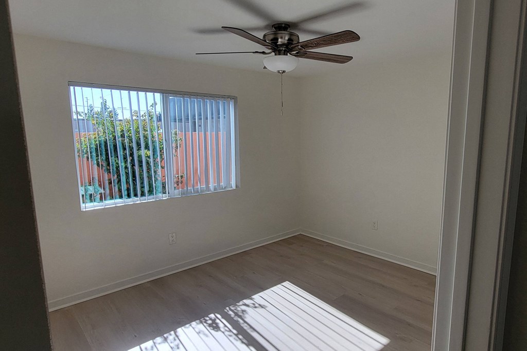 Bedroom two with ceiling fan in unit 21 at The Willows at Washington apartments in El Cajon, California.