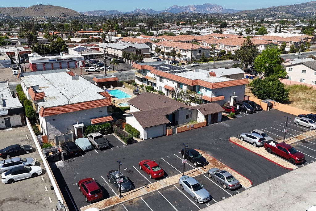 Aerial view of assign parking spaces behind The Willows at Washington Apartments in El Cajon, California.