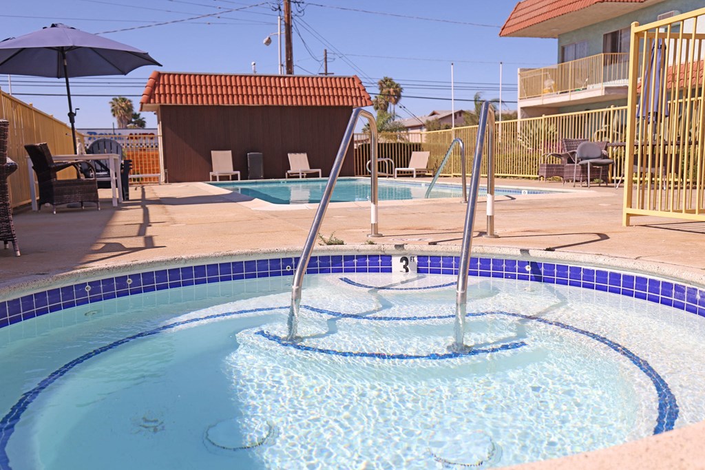 Jacuzzi and swimming pool and sun deck at The Willows at Washington Apartments in El Cajon, California.