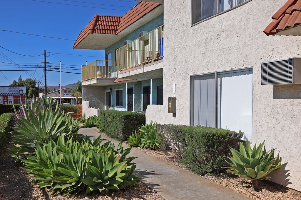 Lush landscaping on walkways at The Willows at Washington Apartments in El Cajon, California.