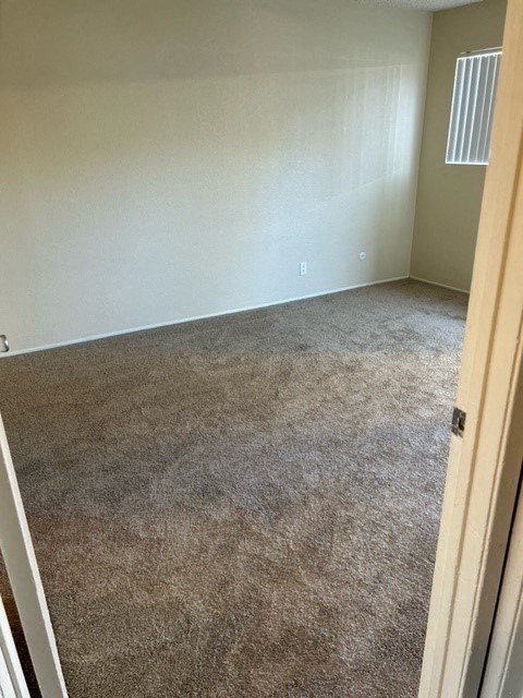 Spacious carpeted bedroom at Mission Bell Apartments.