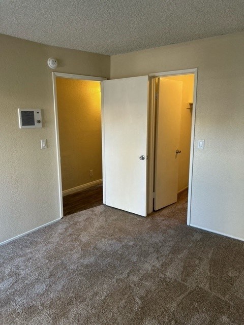Bedroom with walk-in closet at Mission Bell Apartments.