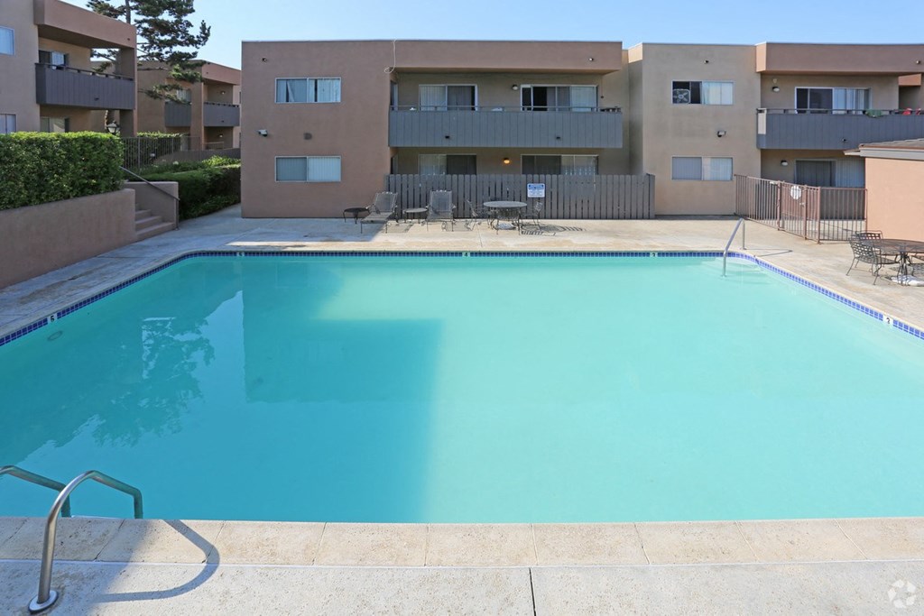 Swimming pool and sun deck at Villa Pacific Apartments in Oceanside, California.