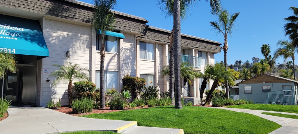 Sidewalk view of the front enterance to La Mesa Village apartments.