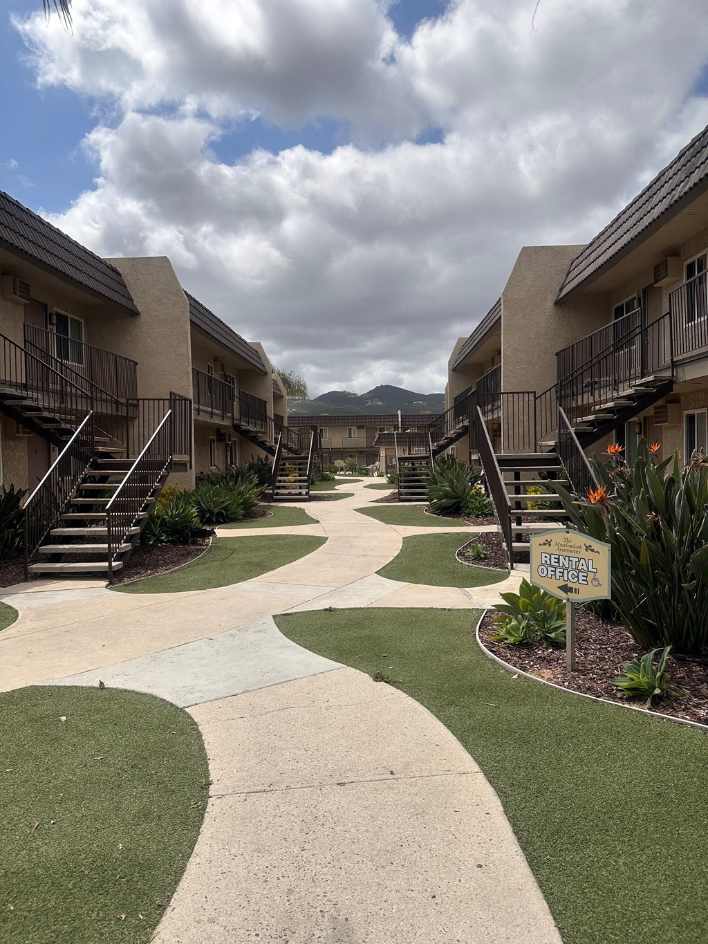 Walkway between buildings at The Meadowlark Apartments in San Marcos, CA.