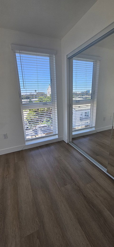 A wooden staircase with a skylight above it.