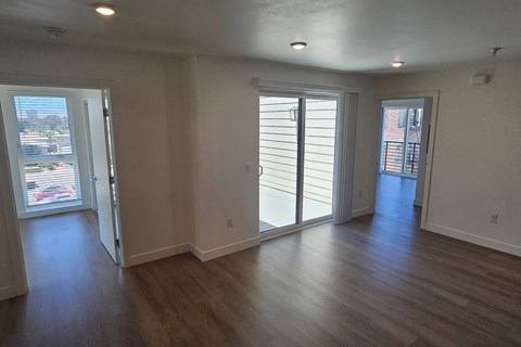 Empty room with wooden floors and white walls.
