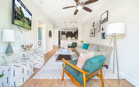 a living room with a couch and a ceiling fan