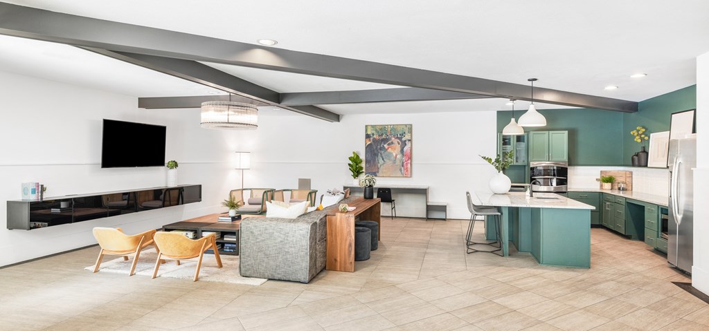a living and dining area with a dining table and chairs and a kitchen in the background