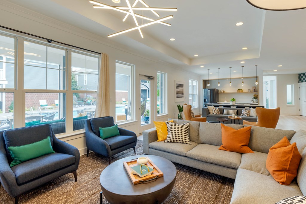 a living room filled with furniture and a large window