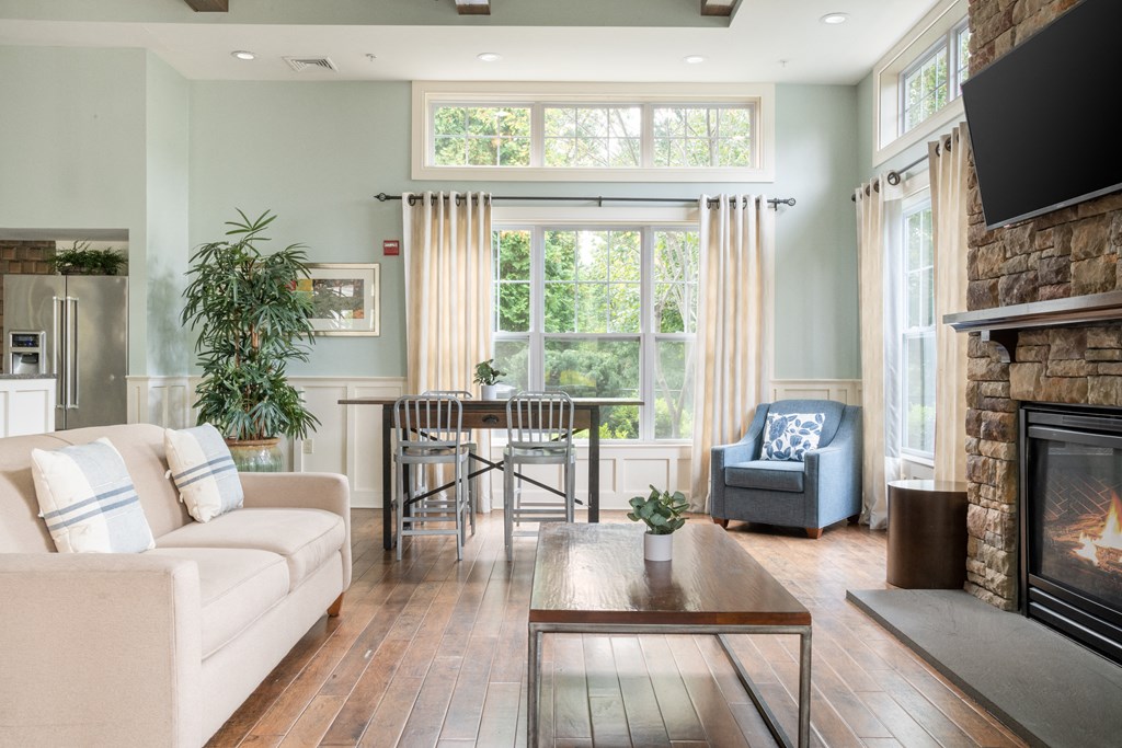 a living room with a fireplace and a large window