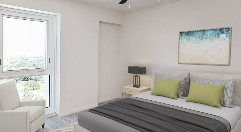 A bedroom with a bed, a chair, and a painting on the wall.