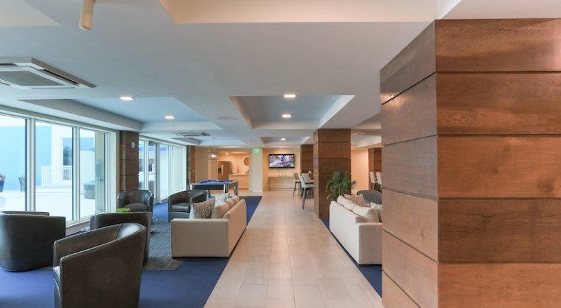 A modern office space with a long wooden table and chairs.