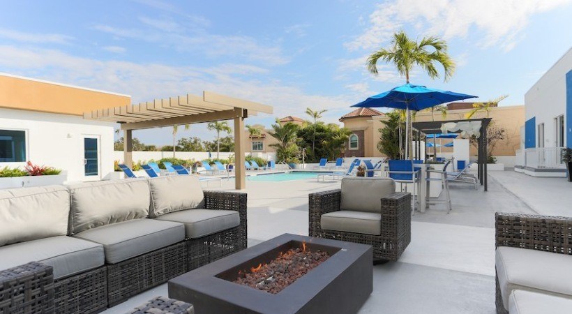 A patio with a fire pit and seating area.