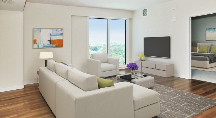 A modern living room with a large sectional sofa and a flat screen TV.