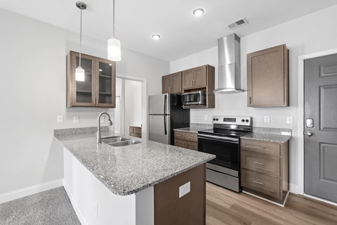 A kitchen with granite countertops and stainless steel appliances.