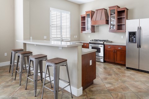 a kitchen with a large island and stools