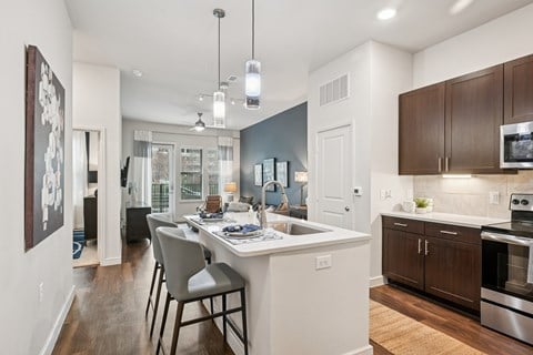 A kitchen with a dining table and chairs.